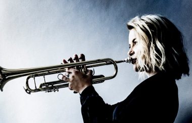 A photo of Bria Skonberg playing a trumpet
