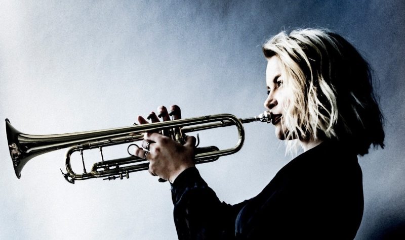A photo of Bria Skonberg playing a trumpet
