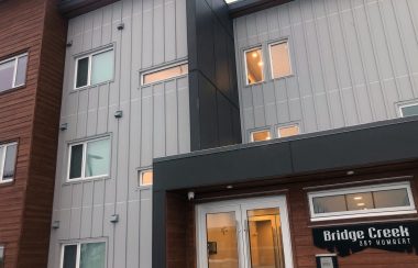 A close up of an apartment complex with a sign in the bottom right corner that says Bridge Creek.