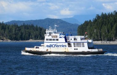 A BC Ferry is seen on the water on a sunny day off the coast of Vancouver.