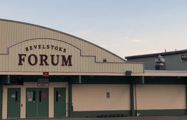 Close up of an arena and curling rink, printing Revelstoke Forum is over the door.