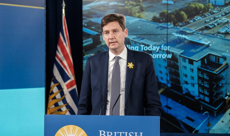 A man speaks behind a podium with British Columbia's government logo.