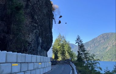Boulders fall from a cliff onto Highway 4 near Cameron Lake