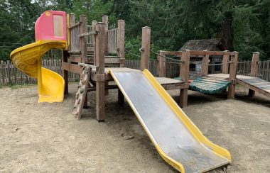 A playground with equipment such as slides and climbing wall.