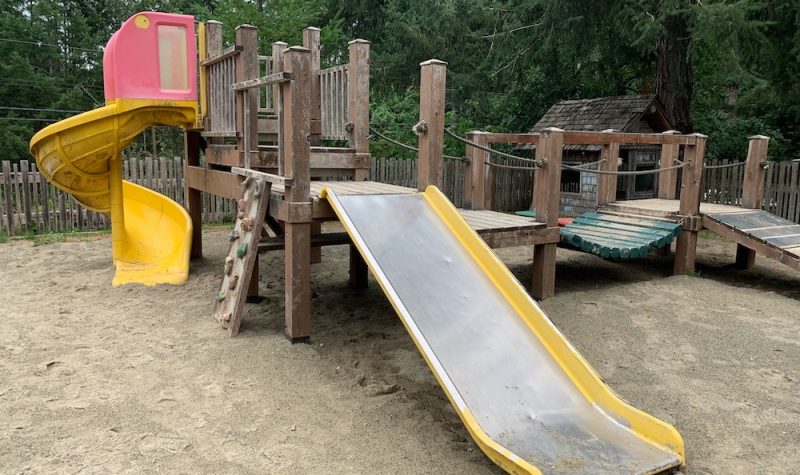 A playground with equipment such as slides and climbing wall.