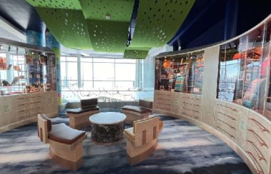 The bright and vibrant Indigenous Interpretative and Retail Centre as shown facing in, with a table and wooden casing in frame.