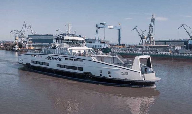 A hybrid electric ferry sailing out of a port full of marine vessels