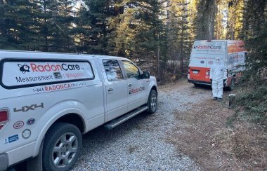 A van and truck parked in a driveway.