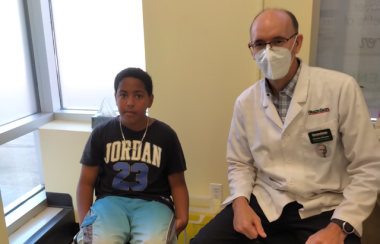 11 year old Deyshaun Tower and Corner Drug Store pharmacist-owner Charles Beaver. Tower received the 7000th dose of COVID-19 vaccines at the Corner Drug on Saturday, August 28, 2021. Photo: Contributed.