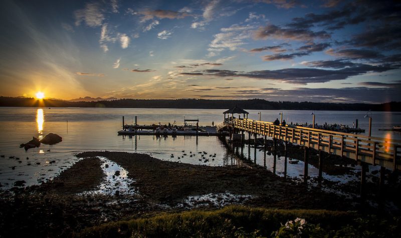 A professional photo of sunrise at Painter's Lodge in Campbell River with a dock and waterfront shown