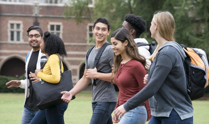 College students are walking outside on their way to their next class.