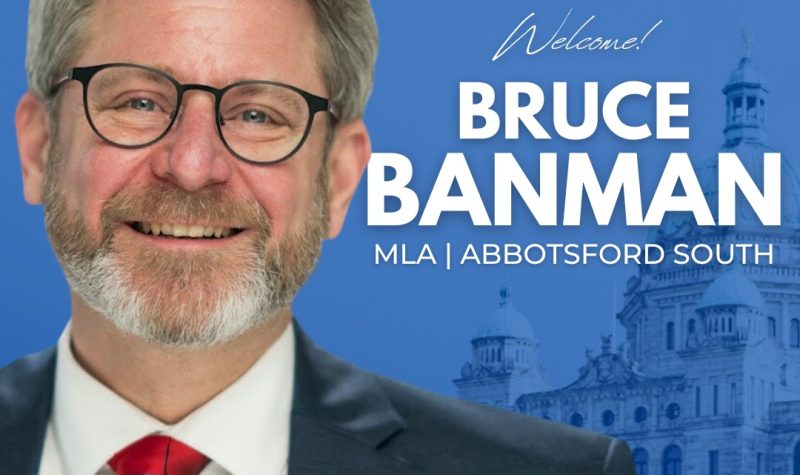 A picture depicts MLA Bruce Batman wearing a white shirt, a black suit, and a red and blue tie. The image is tinted in blue to symbolize the conservative party color, with the BC legislature shown in the background