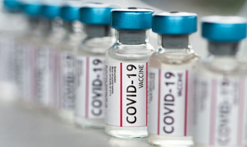 A row of COVID-19 Coronavirus Vaccine vials in a row macro close up