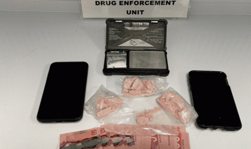 A police photo of illicit drugs, cell phones, Canadian Currency, and a drug scale