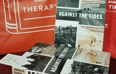 Two copies of the book Against the Tides, sit on display.