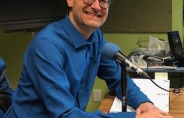 Hydro Quebec representative Alain Paquette sits in CHIP 101.9's studios wearing a blue collared shirt.