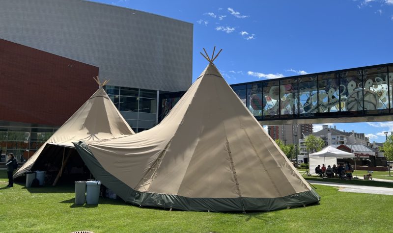 Image shows Dual Tee Pee Tents on for Indigenous Artisan Market on a sunny day.