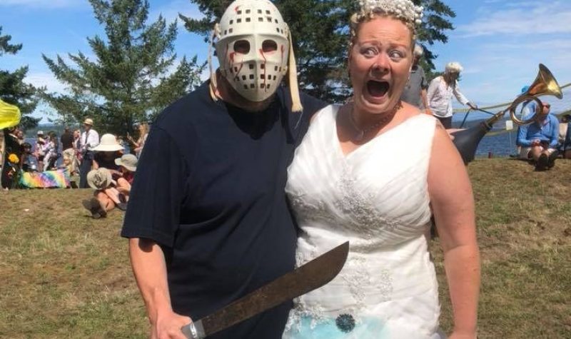 A man in a hockey mask holds a machete to a screaming bride.