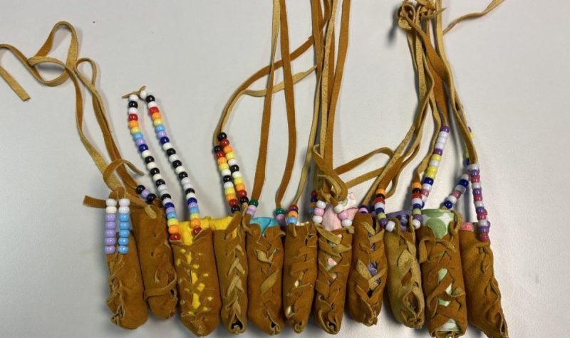 11 small leather bundles with leather strings with some beaded, 2x3' sachels