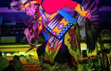 A dancer performing an Indigenous Mi'kmaq powwow dance on stage during last year's Canada Day festival.