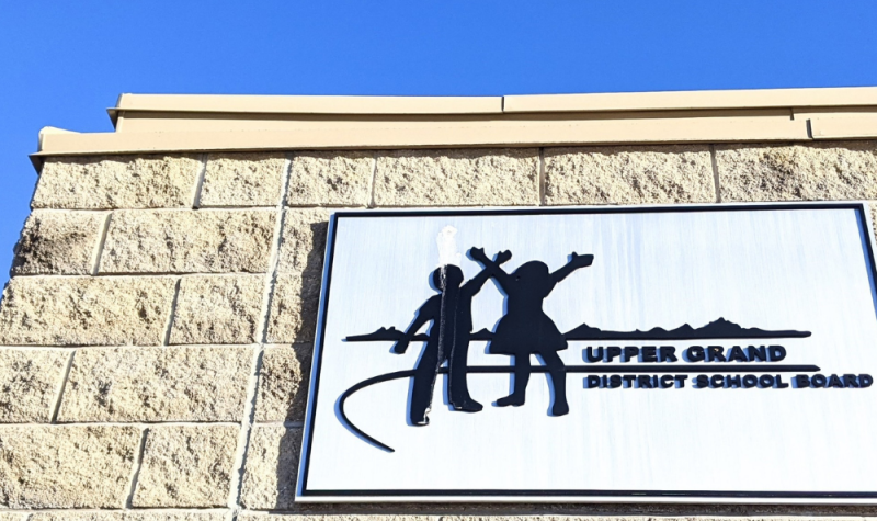 The white and black Upper Grand District School Board logo on a building