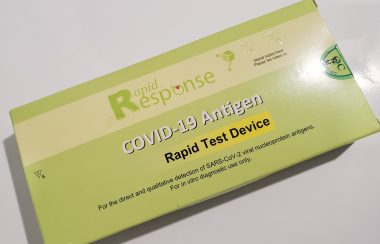 A green COVID-19 test kit package