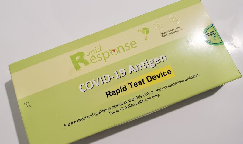 A green COVID-19 test kit package