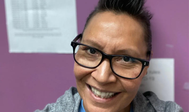 A picture of Tracey Draper, program Coordinator with the Western Aboriginal Harm Reduction Society, against a purple office wall