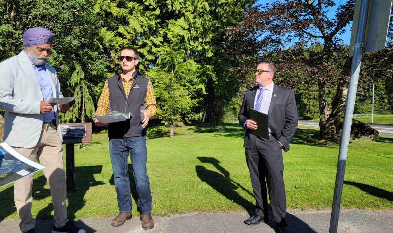 Minister Sajjan standing on the left in a grey suit and purple dastar, Sean Carlson in the middle wearing a yellow plaid shirt and black vest, and mayor Lee Brain on the right in a black suit and sunglasses