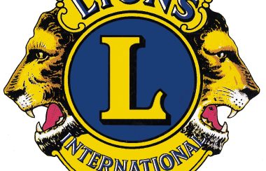 The logo of the Lions Clubs International, gold with a blue background.