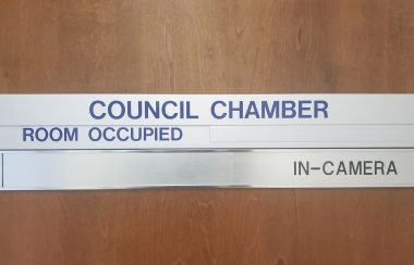 Region of Queens council chamber sign mounted on a door