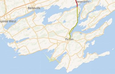 An atlas map of Prince Edward County with a major road highlighted in green and then turns red as it runs north.