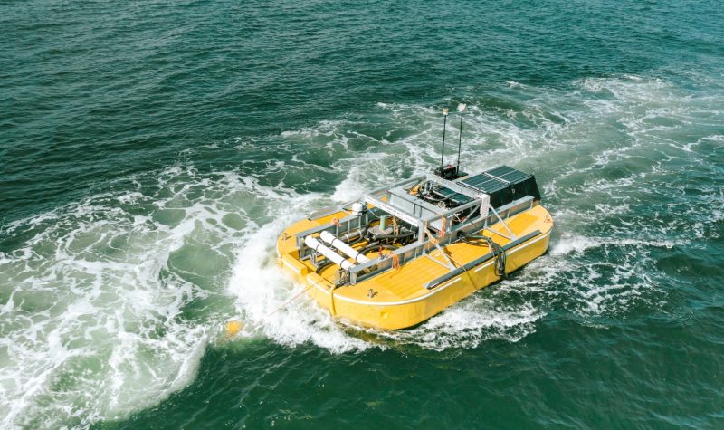 A yellow device on a boat cruises along green waters. Iceberg-class desalination unit