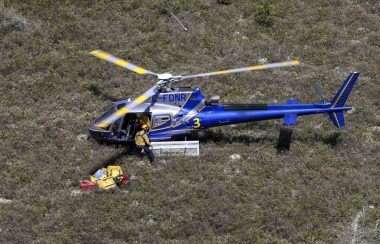 A helicopter is unloaded in a field