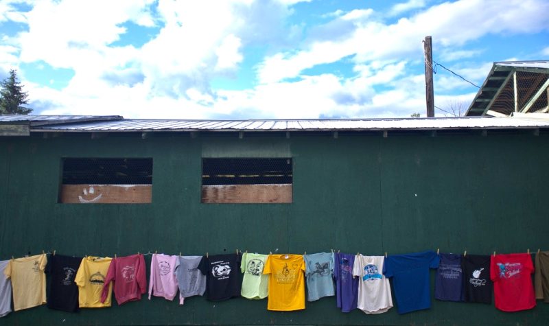 A clothes line holds up tshirts and sweatshirts from the many years of the Midsummer Music Festival.