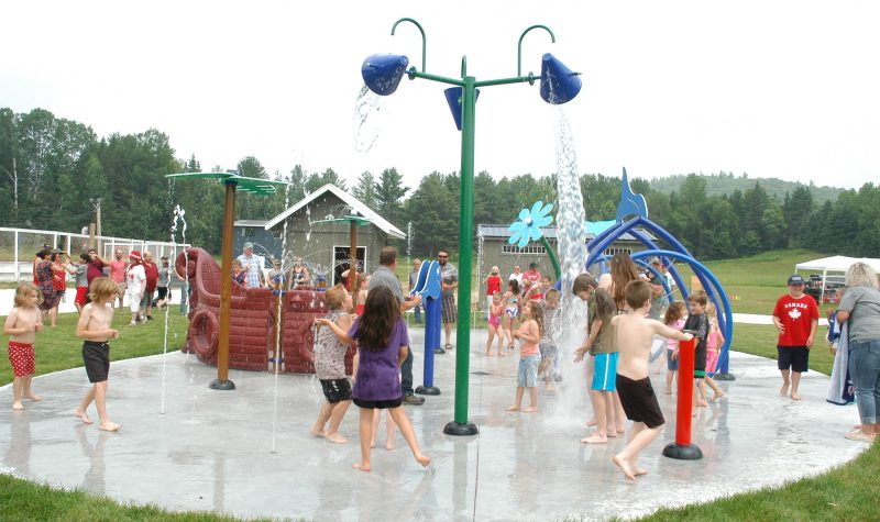 A group of children playing in a splash pad.