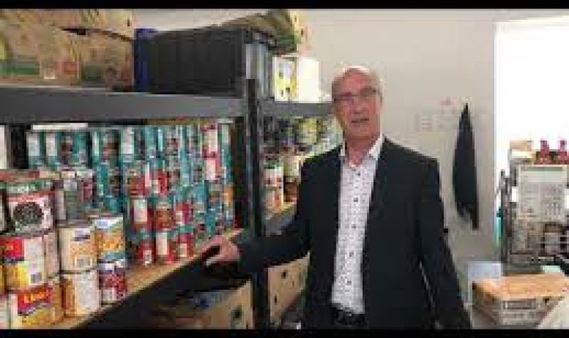 Dave Murray pictured in the Abbotsford Food Bank near some shelves of canned goods.