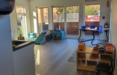 An infant playroom with change tables, a play mat and toys