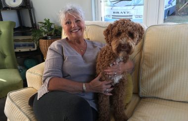 Debbie Wiggins-Colwell at home with her dog Preston. Photo: Erica Butler