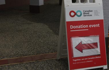 A placard shows the way to a blood donation location