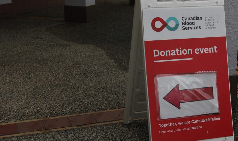 A placard shows the way to a blood donation location
