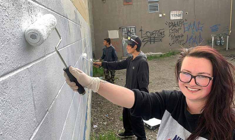 One of the POUND's Project initiatives. Pictured is Jordan Harris, Executive Director of POUND's, and POUND's clients working to clean up Prince George by painting over graffiti..