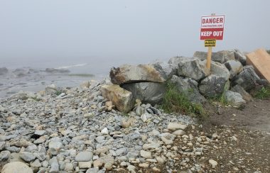 A no trespassing sign posted along a beach road