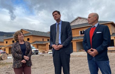 Eby, Atrill and Cullen in front of housing development