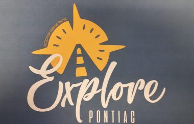 The logo for Explore Pontiac, featuring a highway on a golden compass with the word explore in stylized letters.