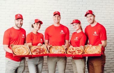 5 personnes avec des pizzas à la main