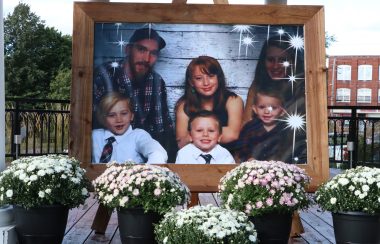 A photo of a family on display surrounded by flowers