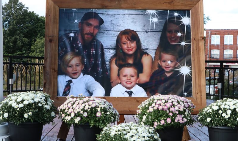 A photo of a family on display surrounded by flowers