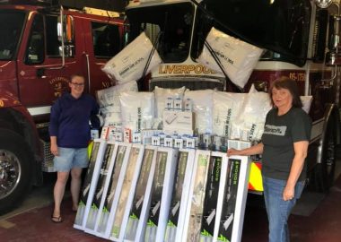 A photo of ladies auxiliary members with donations for Liverpool fire department.