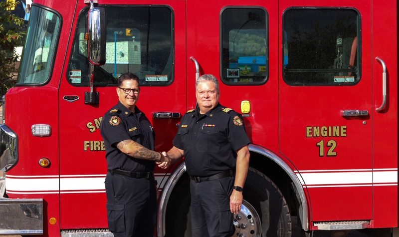 Outgoing Fire Chief Stecko shakes the hand of Deputy Chief Zacharias who will become Chief on December 1, 2021.